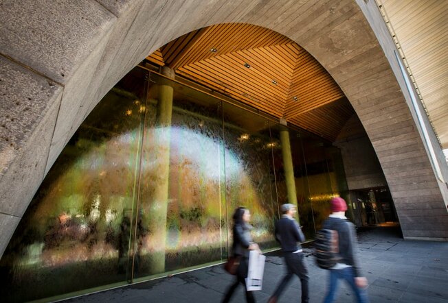 People leaving the NGV, walking past its distinctive water wall.