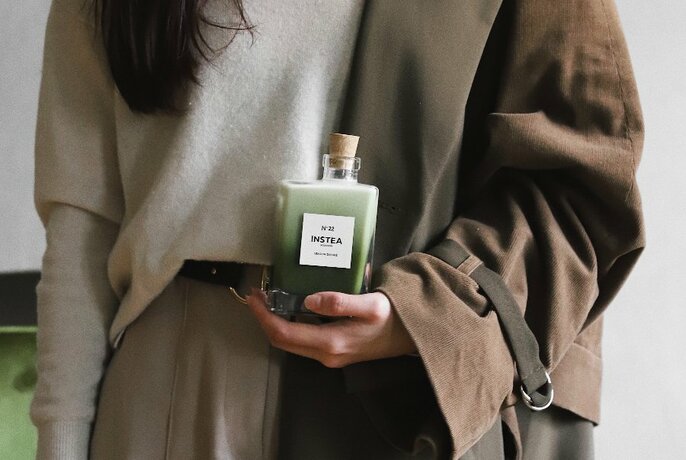 Model with bottle of green tea.