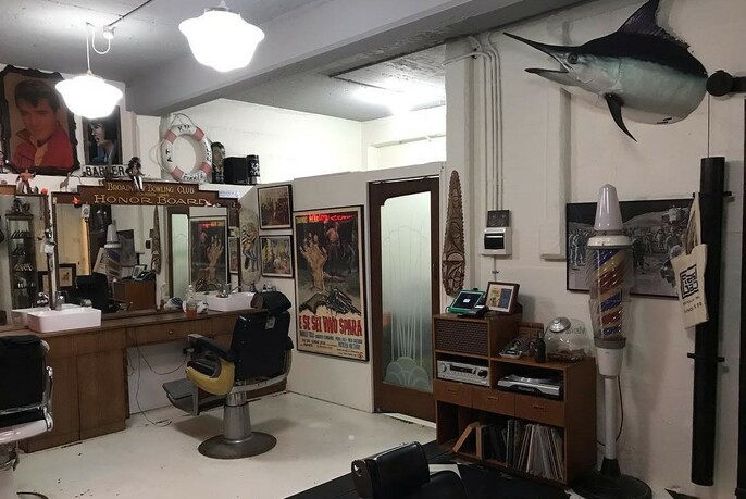 Barber shop with stuffed marlin head mounted on the wall.
