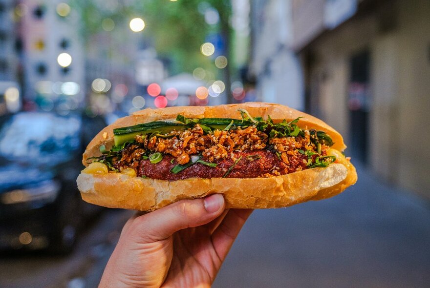 A banh mi filled with cucumber and crispy meat.