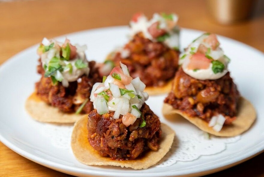 Mini tacos with meatballs on.