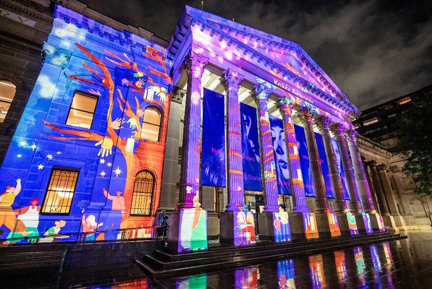 State Library Victoria portico and facade illuminated for Christmas in blue and purple details.