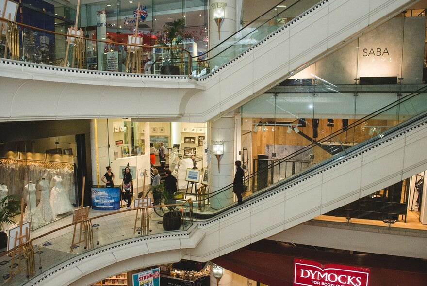 Inside Collins234 shopping centre, showing several levels of shopping, connected by escalators.