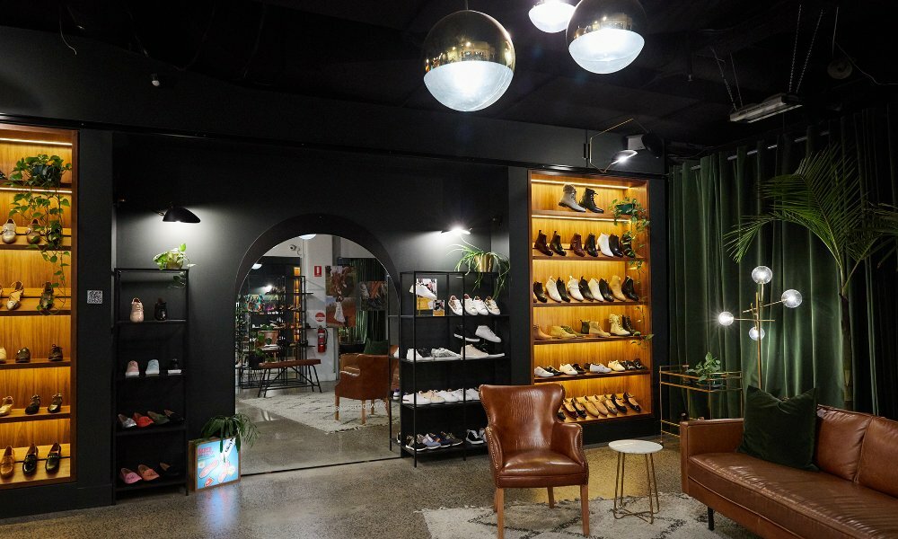 A footwear store with sneakers and boots on display.