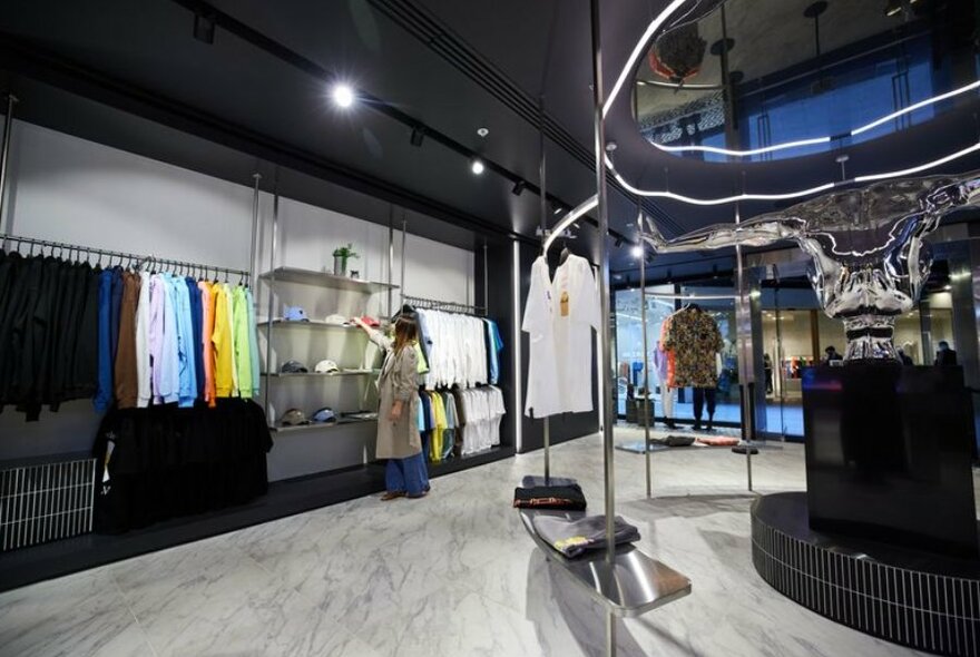 A futuristic streetwear store with colourful jumpers and caps.