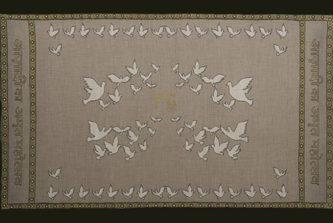 An example of Indian woven textiles with decorative birds flying in a pattern. 
