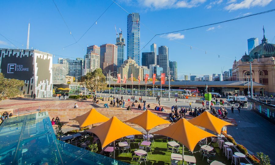 View over cafe umbrellas to the central Melbourne skyline.