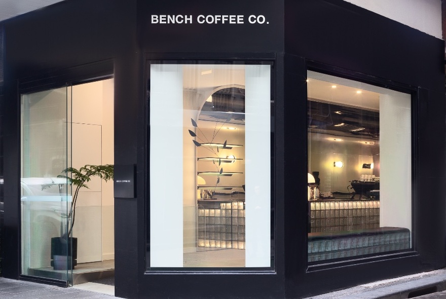 Exterior of Bench Coffee Co with large glass windows.