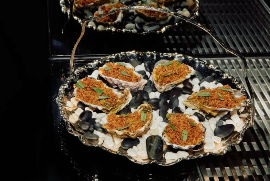 Vintage silver tray topped with dressed oysters.