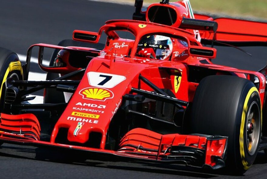 Ferrari Formula 1 racing car driving on a racetrack.