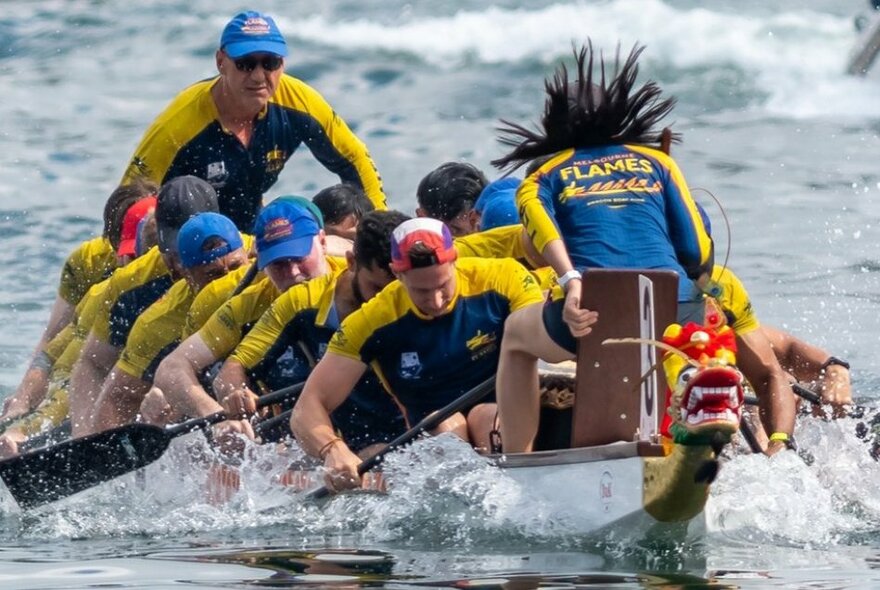 A team of dragon boat racers on the water.