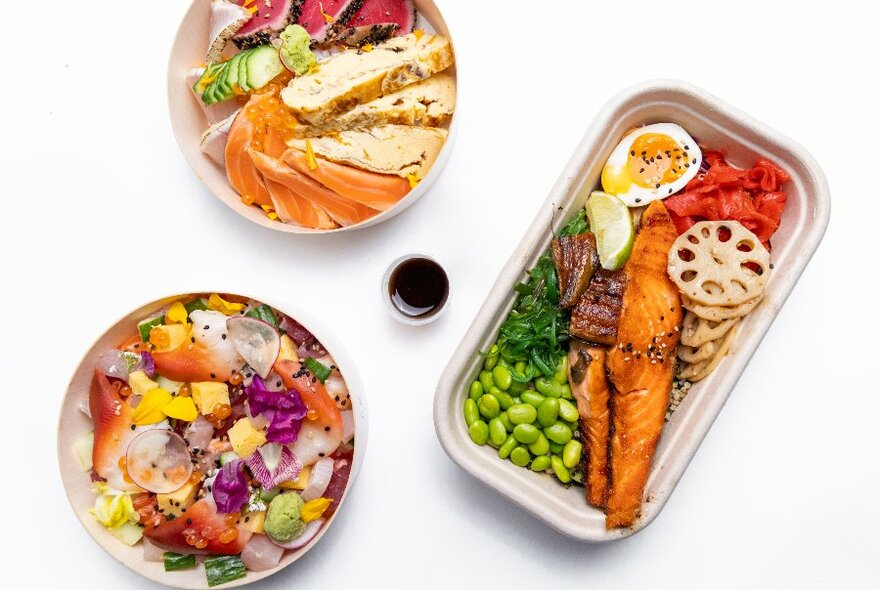 Japanese takeaway dishes including colourful bowls and a salmon bento box.