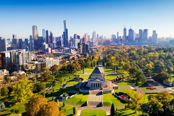 Aerial view of the Shrine of Remembrance, surrounding parklands and the city buildings .