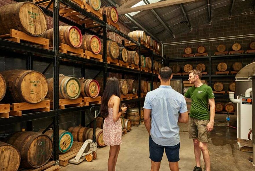 Three people in a distillery 
