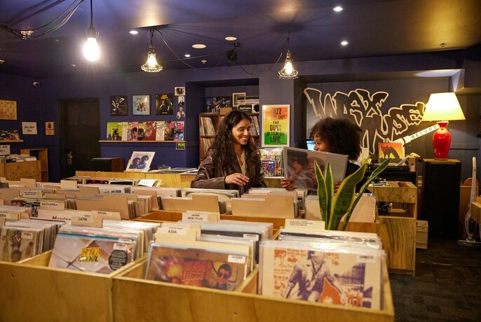 Two people browsing in a record shop.