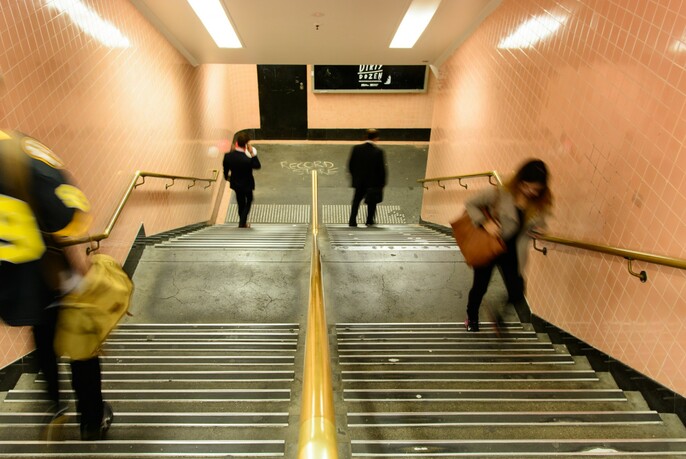 People on stairs in a subway.