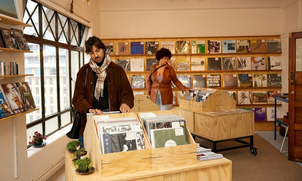 Two friends are browsing records in a record store