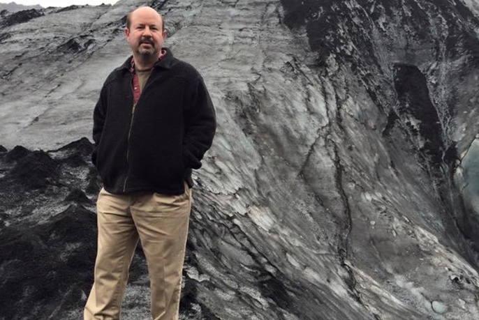 Man standing in front of a glacier.