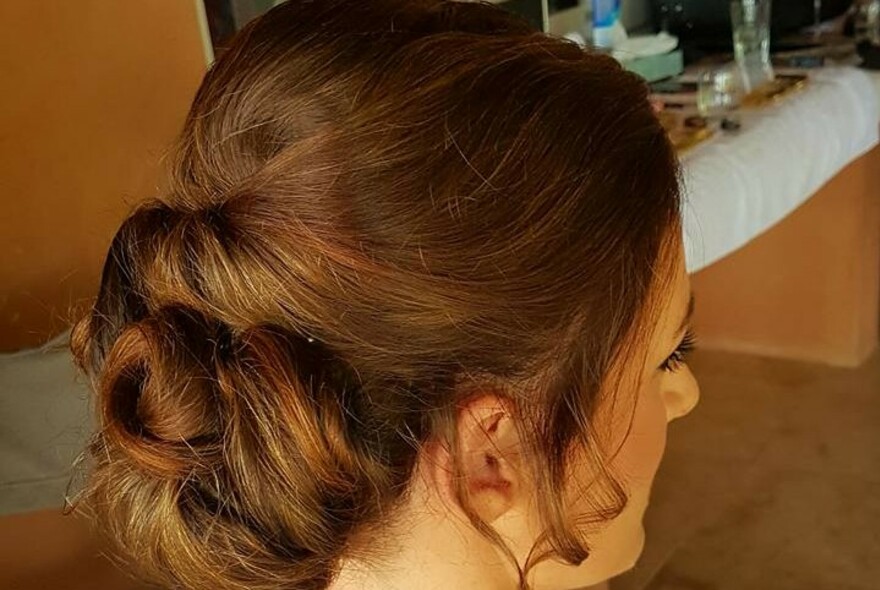 Read view of a woman's updo in a salon.