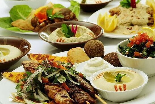 Bowls of Lebanese food, including falafel balls and dips.