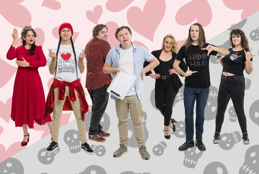 An ensemble of seven actors, all holding a particular pose or making gestures with their hands or faces, posed in front of a backdrop of drawings of red hearts or grey skulls.