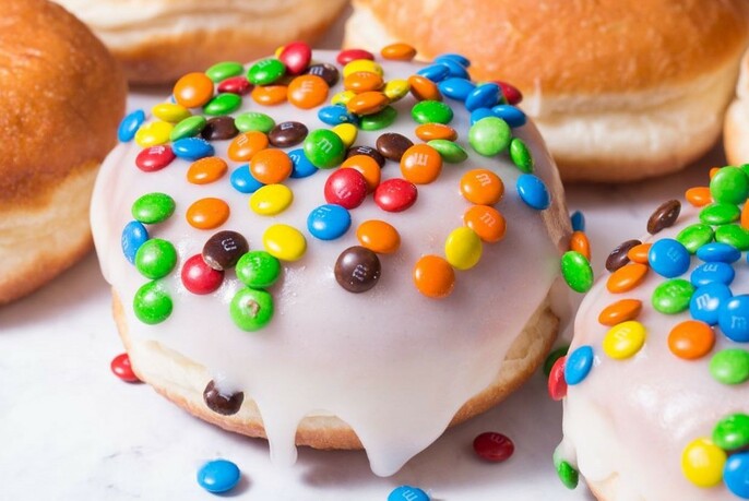 Iced donut topped with MnMs.