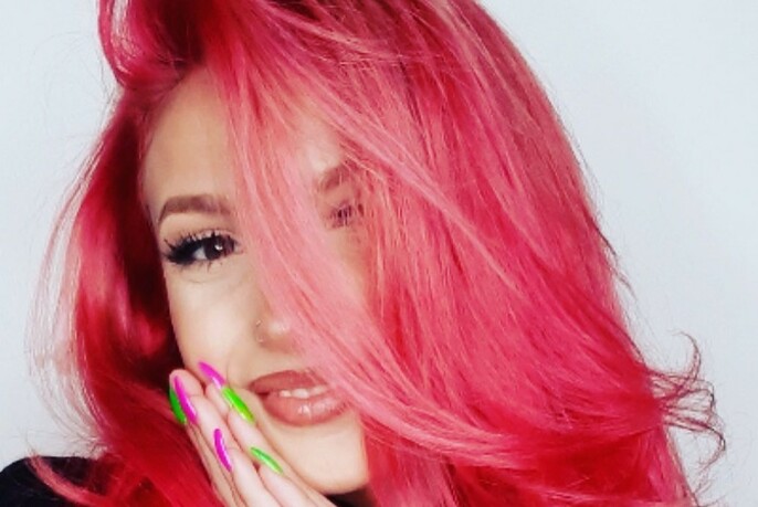 Woman with bright pink hair.