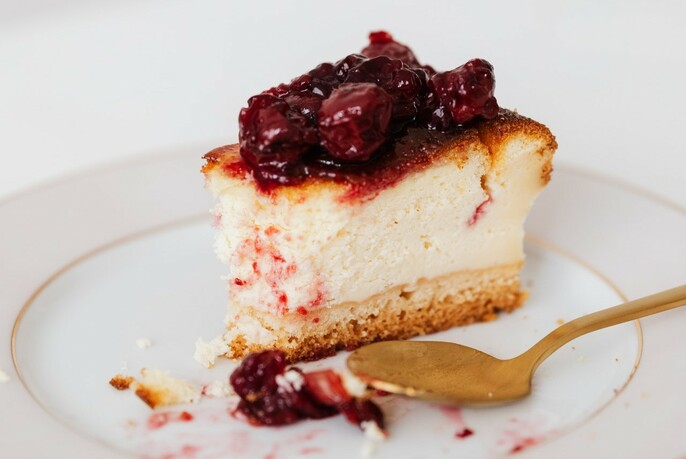 Slice of cheesecake with cherries.