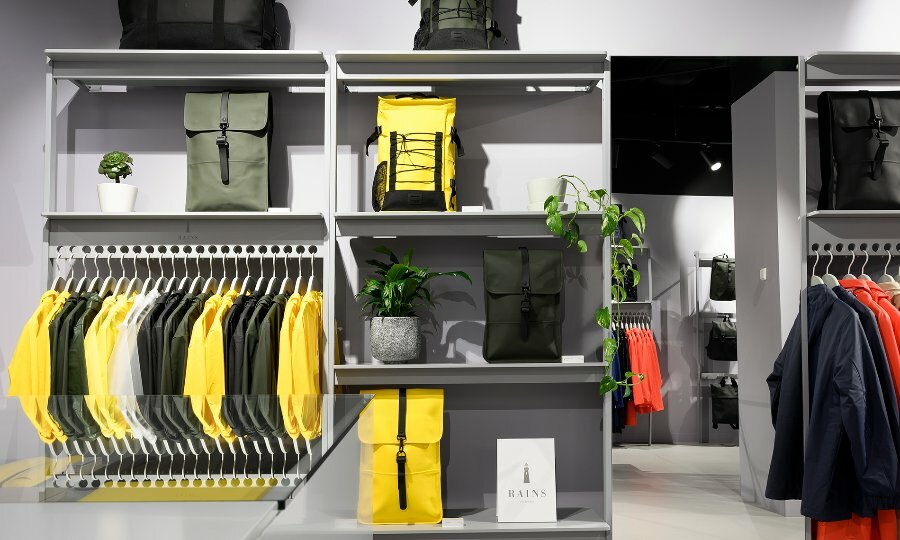 A retail store selling outdoor clothing and leather backpacks in shades of black, red and yellow.