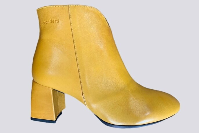 One yellow leather high-heeled ladies boot.