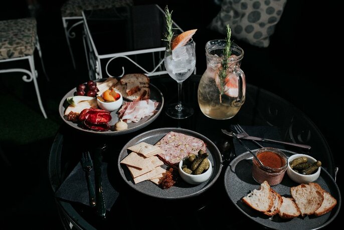 Dishes of snacks and drinks on a table.