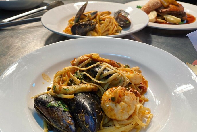 Plate of seafood pasta with mussels and prawns.