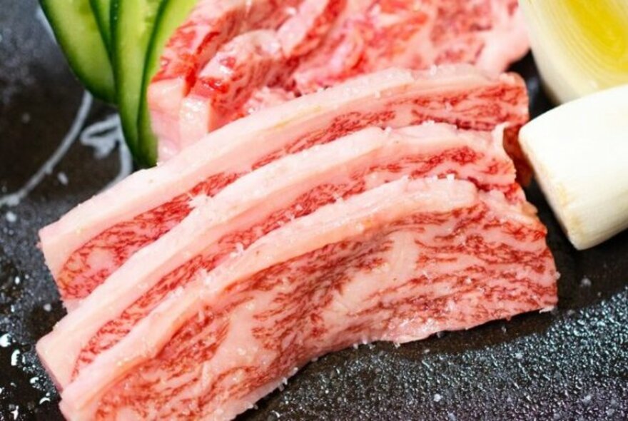 Slices of raw  wagyu beef.