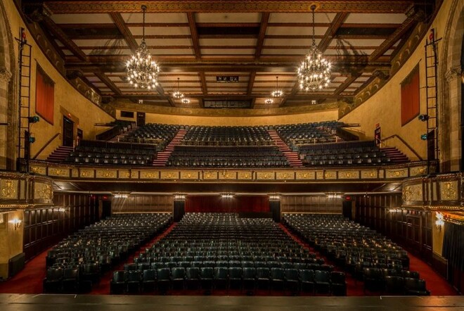 Inside Comedy Theatre, with 2 tiers of seating.