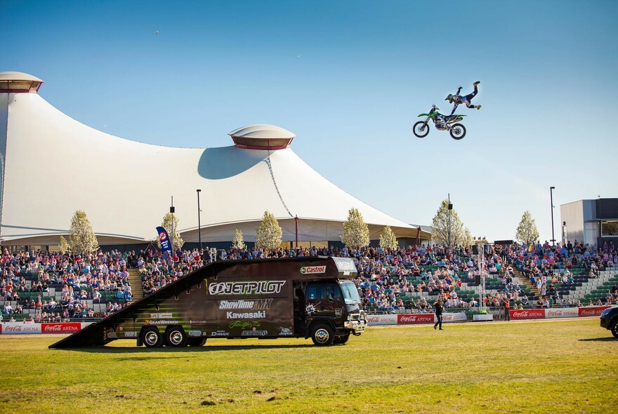 Dare-devil motorbike stunt at Melbourne Showgrounds.