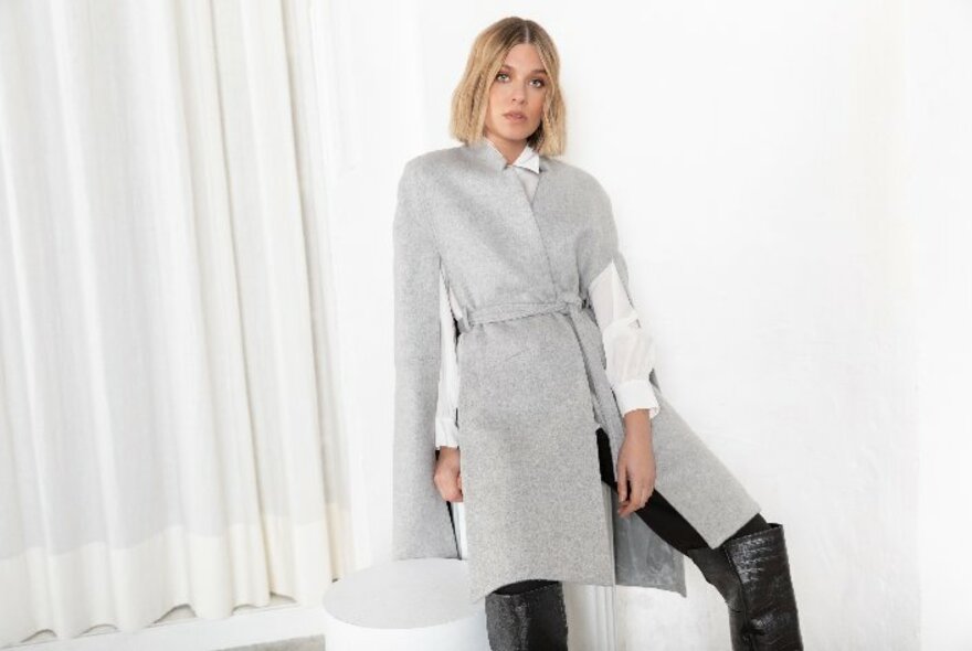 Model wearing a grey wool cape-coat.