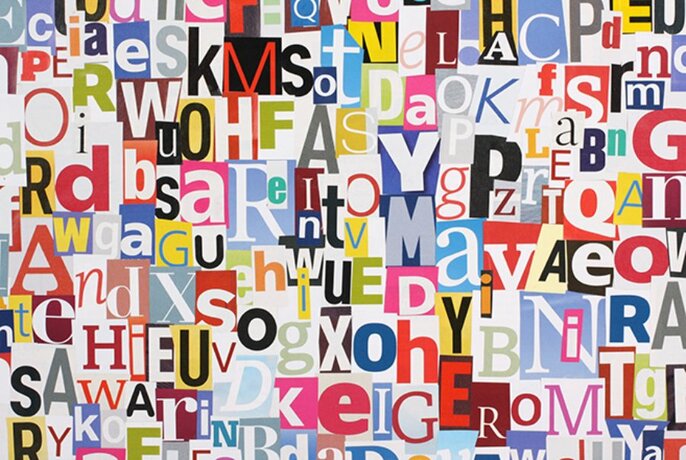 Random cut out letters all pasted together in a jumble. 