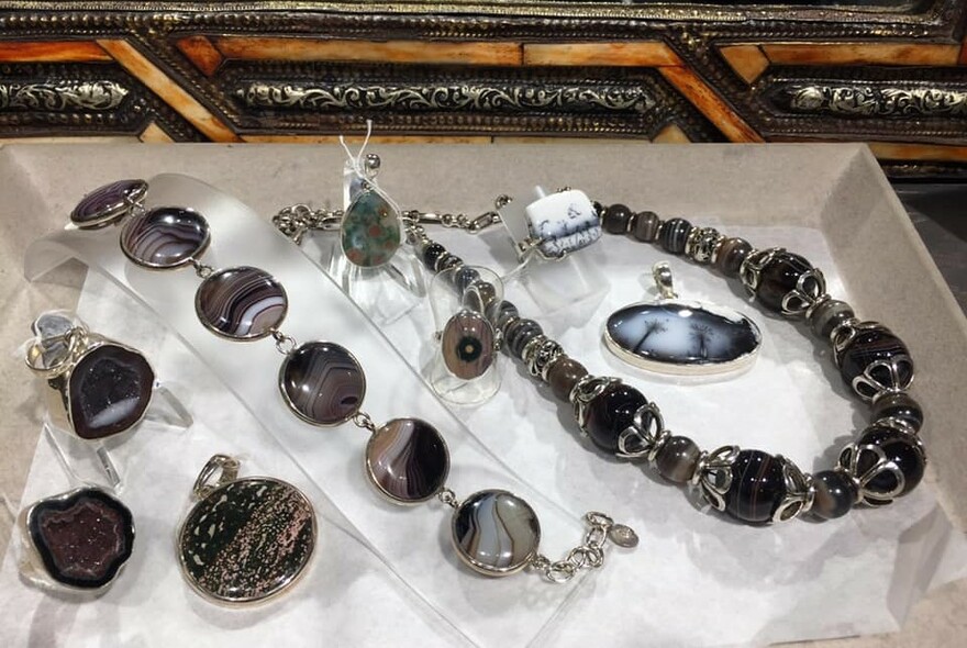Gemstone necklaces and pendants in a showcase.
