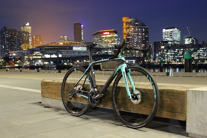 Bike resting on a bench city with city skyline in the background.