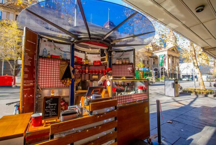 An outdoor kiosk serving french crepes.