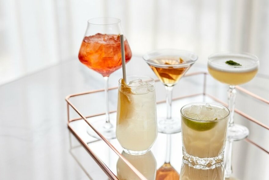 Drinks in a range of cocktail glasses.