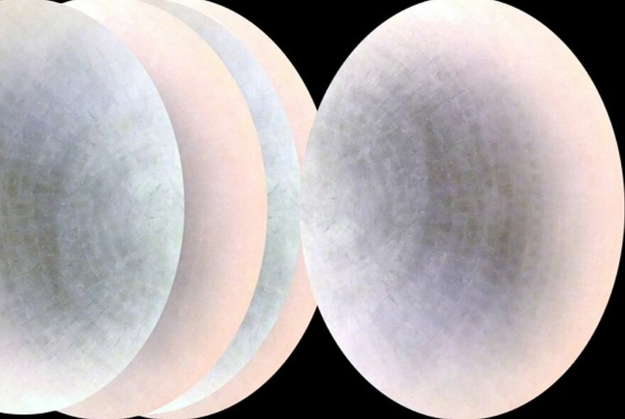 Pastel shaded pearl-like spheres against a black background.