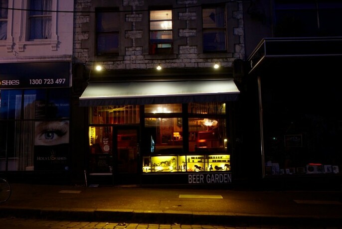 Street view of Prudence at night - a cosy little bar in North Melbourne.