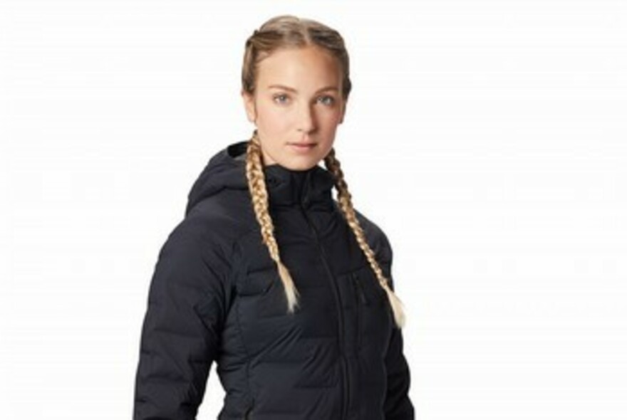 Woman wearing a zip-up, hooded jacket. 