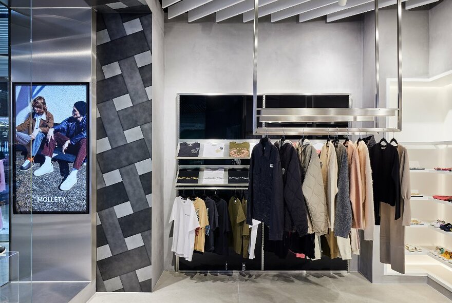 Clothing hanging on racks in the Onitsuka Tiger flagship store in Melbourne.