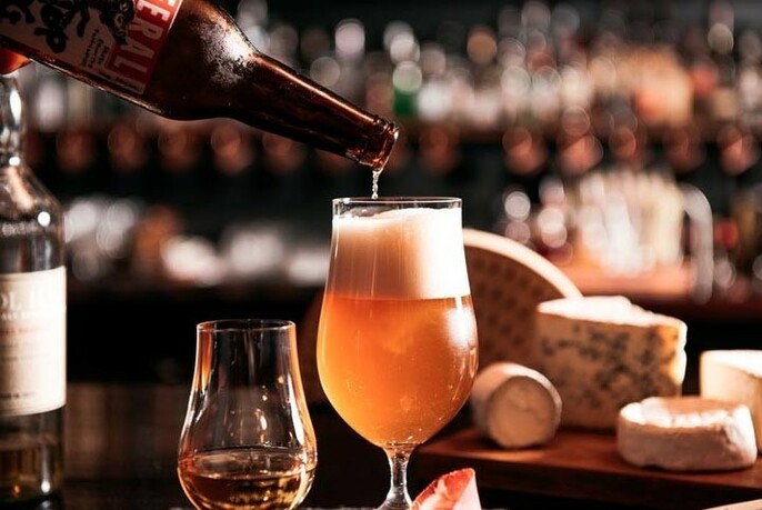 Beer being poured from a bottle into a glass.