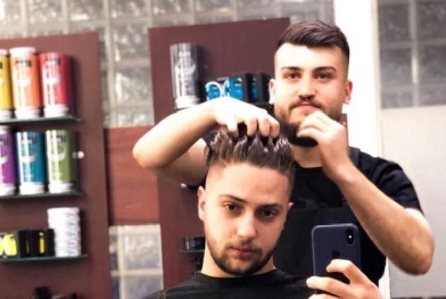 Man getting a haircut in a barber shop.