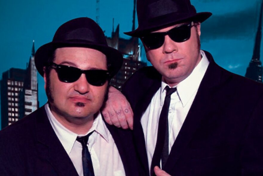 A scene from the movie The Blues Brothers, with Jake and Elwood in their black hats and glasses. 