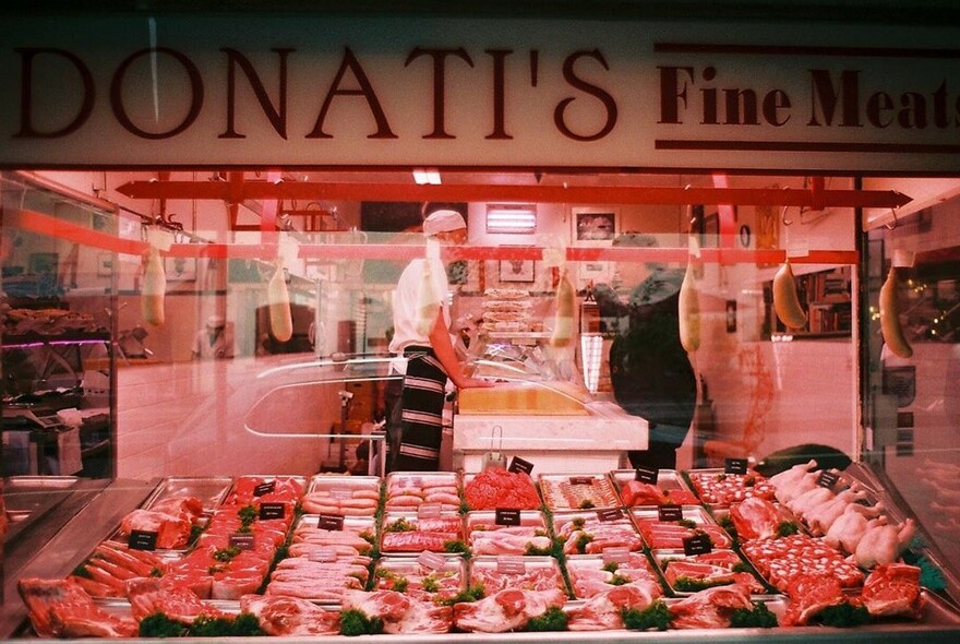 Butchers shop displaying various pieces of meat.