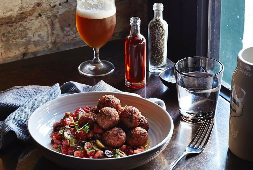 Meatballs and a glass of beer.